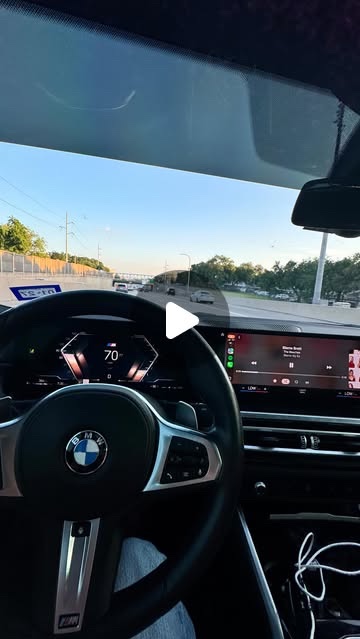 Cover: a BMW steering wheel and dashboard on a Texas highway